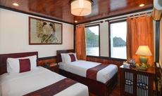 A bed or beds in a room at Oasis Bay Classic Cruises