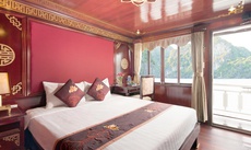 A bed or beds in a room at Legacy Cruise